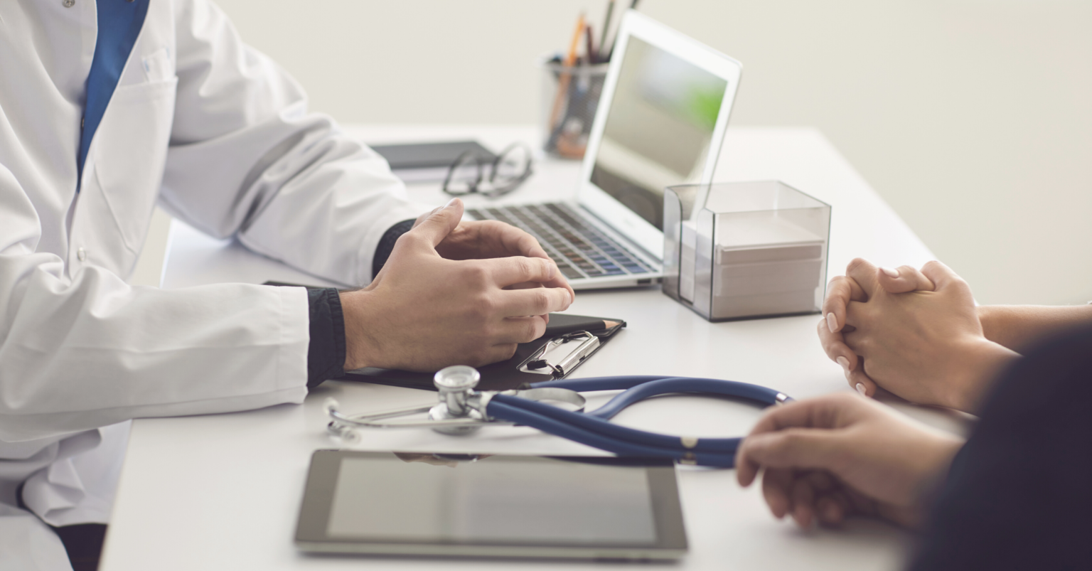 Doctor sitting at a desk with a patient