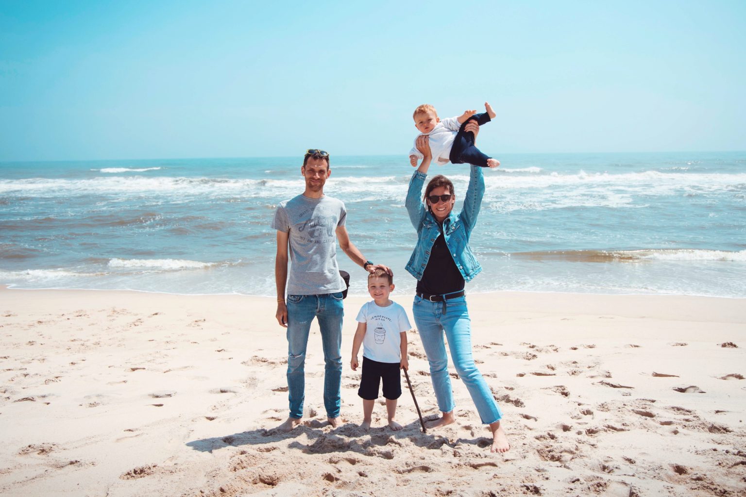 A family of 4 having fun at the beach